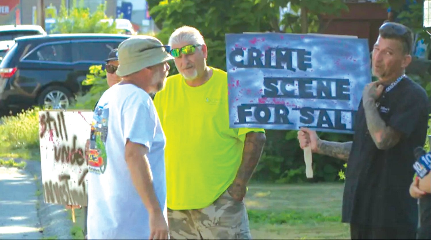 HE HAS A SIGN TOO: David Viens is the father of Dillon Viens, 16, a Johnston resident and student at who died following a “shooting” at 78 Cedar St. The home is now for sale, and David picketed a recent Open House. He carried signs reading: “CRIME SCENE FOR SALE” and “Open Investigation for SALE,” and wanted to ensure potential buyers knew what happened in the house. (Submitted photos)